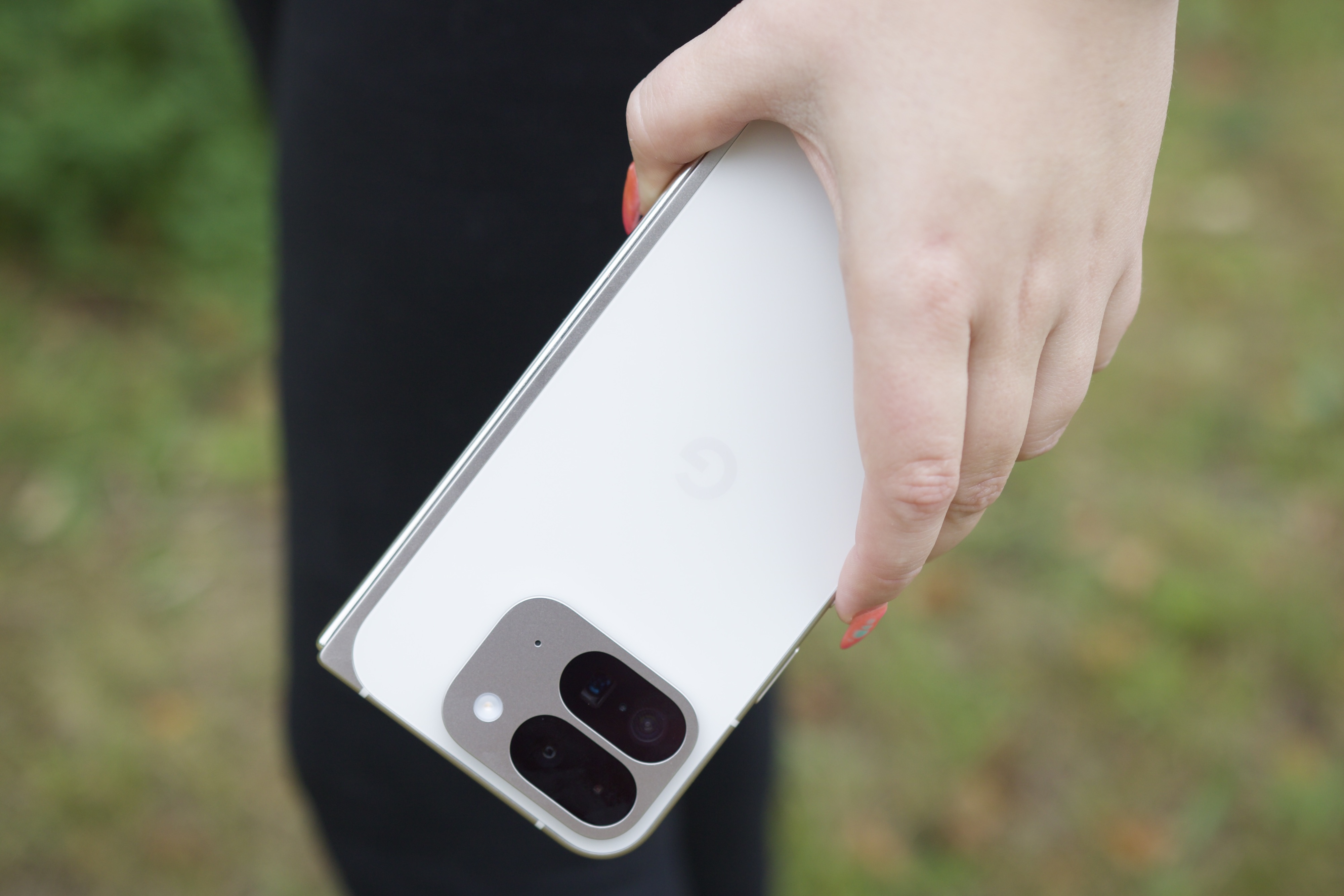 Une personne tenant le Google Pixel 9 Pro Fold, montrant l'arrière du téléphone.